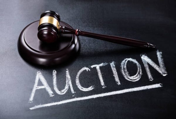 Close-up Of Auction Concept With Brown Gavel On Blackboard Close-up Of Auction Concept With Brown Gavel On Blackboard